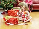 Girl opening Christmas gifts